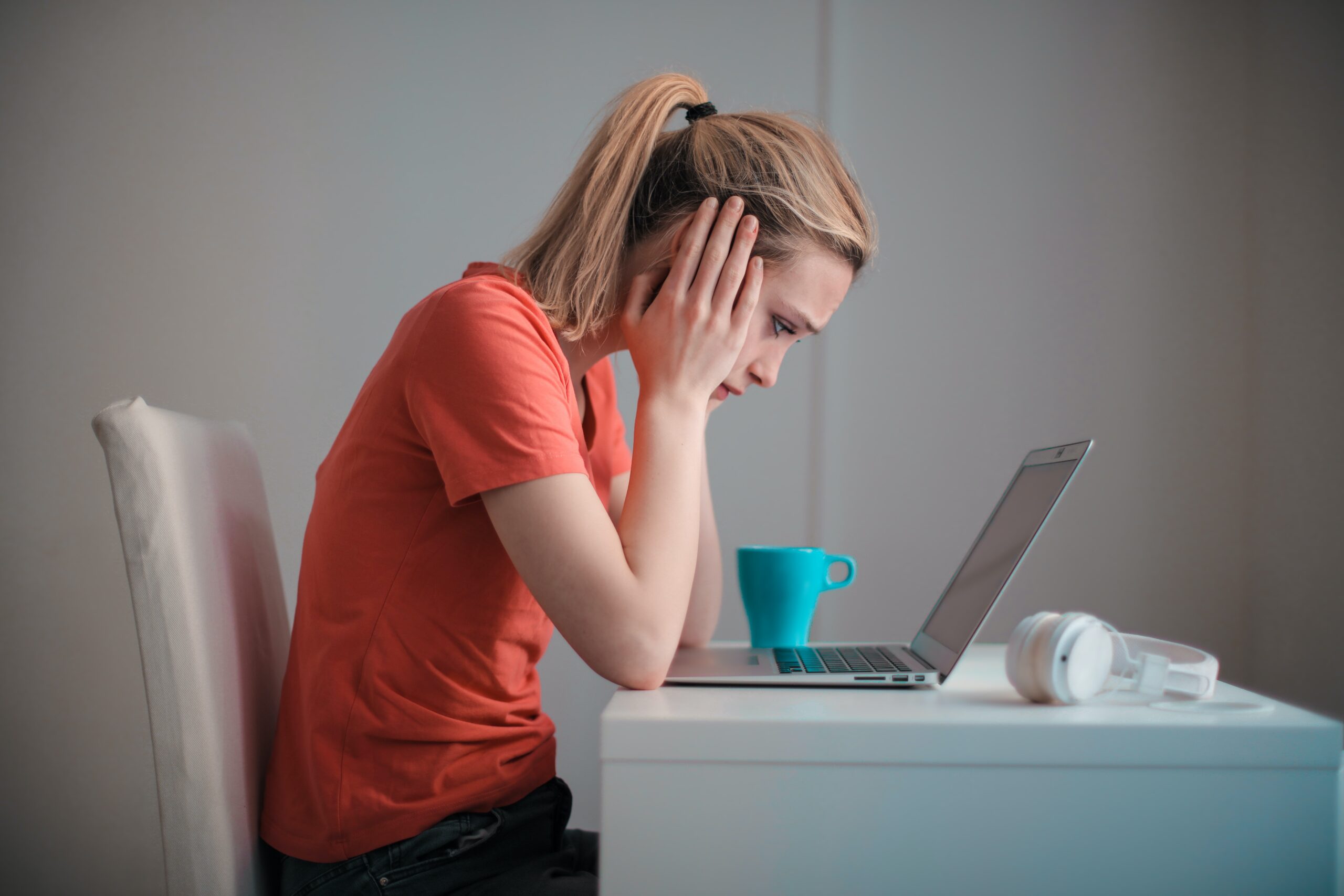 Woman at desk feeling undervalued.